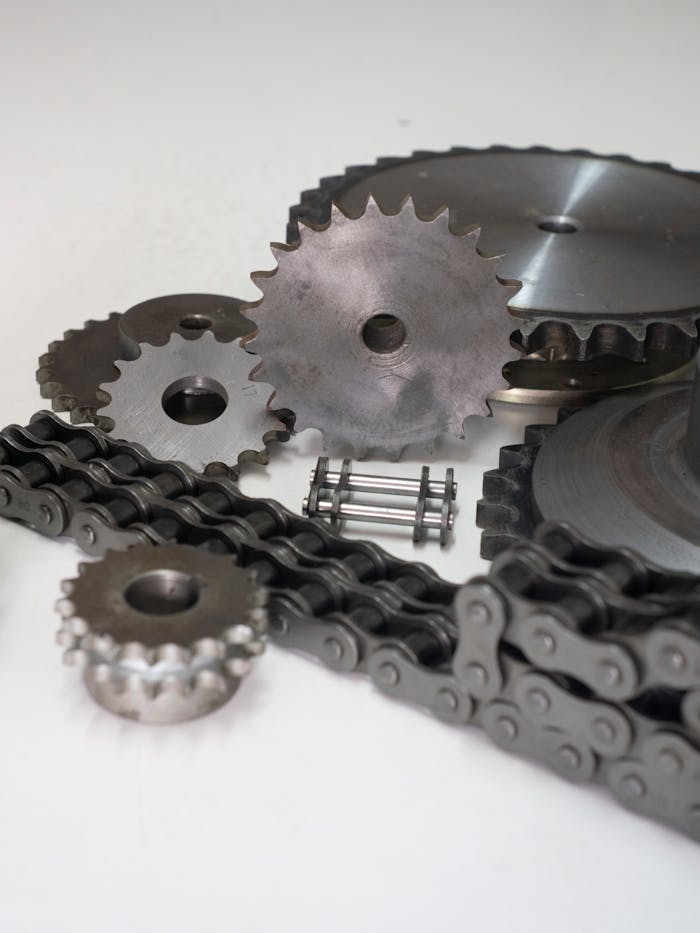 Close-up of metal gears and chains showcasing industrial engineering parts.